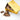 A gold metal tin of Harbor Sweets chocolate bark with pieces broken and scattered on a white marble surface. The tin lid features the Harbor Sweets logo.