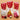 Four chocolate bars in red packaging with snowflake patterns on a beige background
