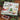 Chocolate Christmas calendar with festive design on a wooden surface with Christmas decorations.