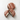 Chocolate-covered cookies with pink and white drizzle on a white background